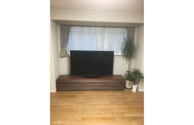 窓の前に設置された大川家具の無垢テレビボード(オーキタ家具)