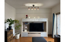 照明に照らされる大川家具の収納付きテレビボードとチェストとオットマン(近新)